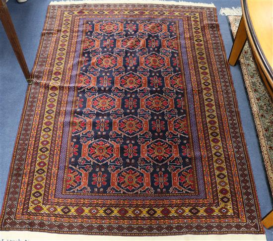 An Afghan blue ground rug 180 x 127cm
